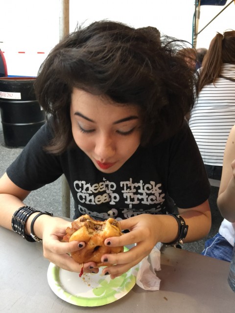 Opinion Editor Angeline Stein digging into her burger at the 2015 Allentown Fair. Photo courtesy of Angeline Stein