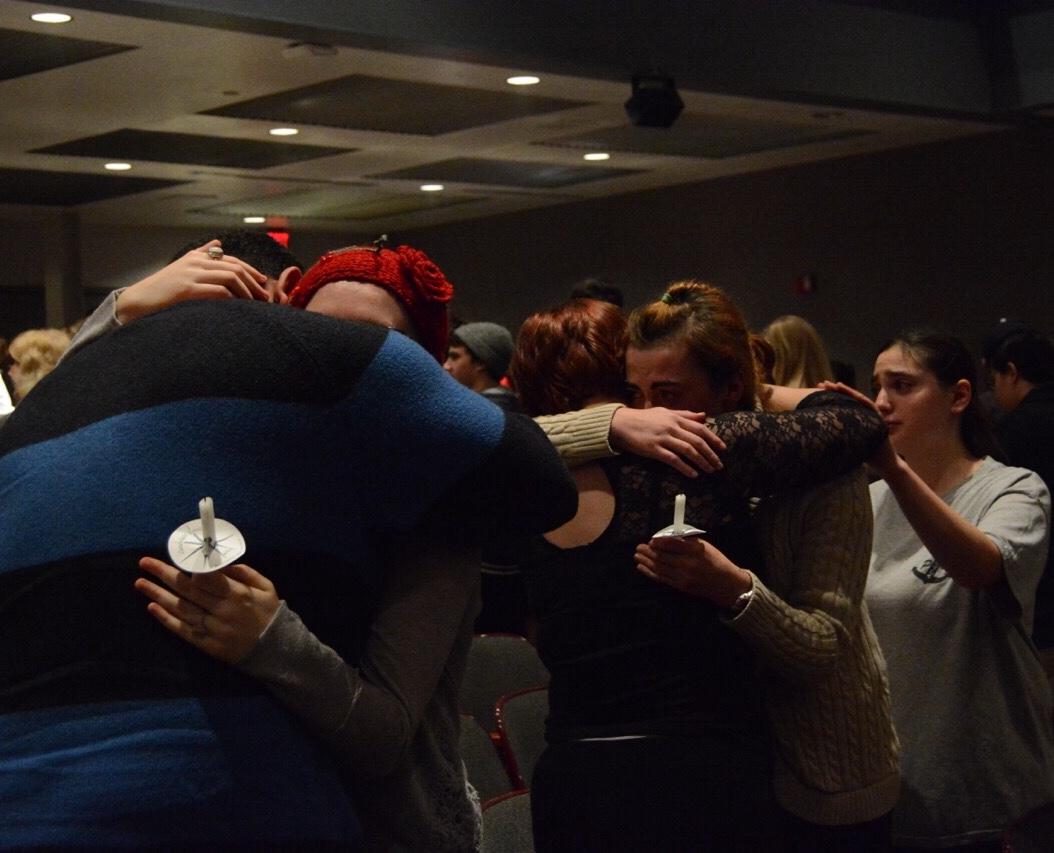 Former EHS students embrace one another as the emotional night comes to a close. 