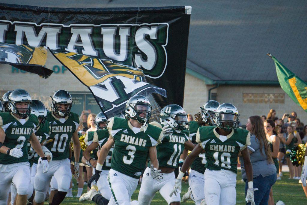 The Emmaus Green Hornet Football Team enters the field for their first home game on August 30. Photo by Alice Adams.
