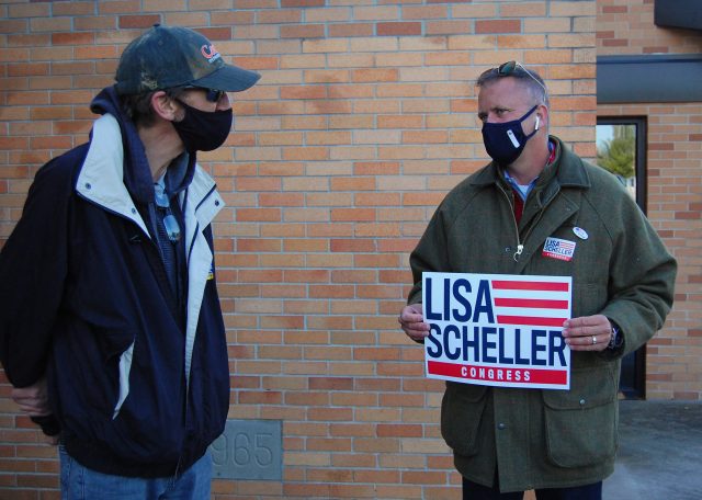 Miller talks to Howard Schaeffer, another volunteer at the polls. “Our country is at a crossroads right now, and I don’t think we should lose our American way,” Schaeffer said. Photo by Meliha Anthony.