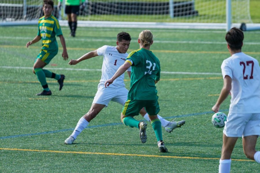 Senior Holden Brown fights for the ball against a Whitehall Zephyr at a soccer game on Sept. 10. Emmaus tied with Whitehall with a score of 2-2. Photo by Alice Adams.