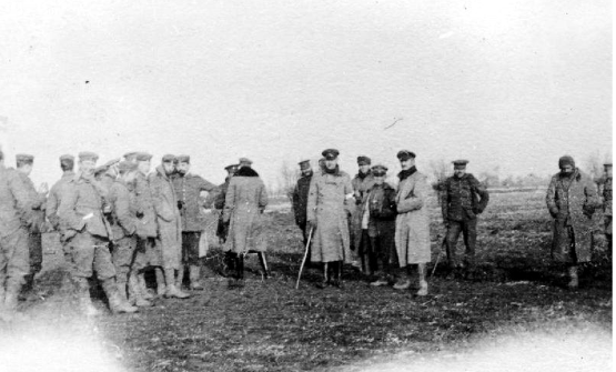 Photo Courtesy of Wikipedia Commons

German and British soldiers meet during the temporary peace. They exchange gifts, pose for photographs, and give proper burials to their dead comrades.