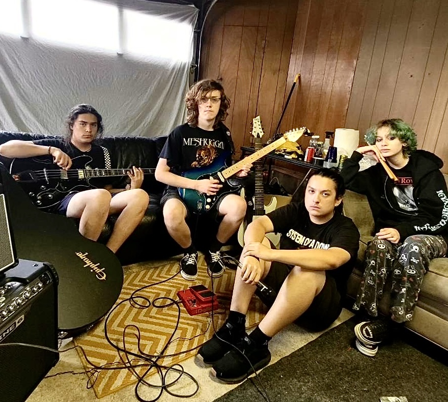 Controlled Chaos set up to practice inside of the Schmidt family’s garage, surrounded by 
recording equipment on July 1, 2023. Left to right: Paul Schmidt, Chris Tucker, Hayden David, Vic Schmidt. Photo Courtesy of Hayden David.
