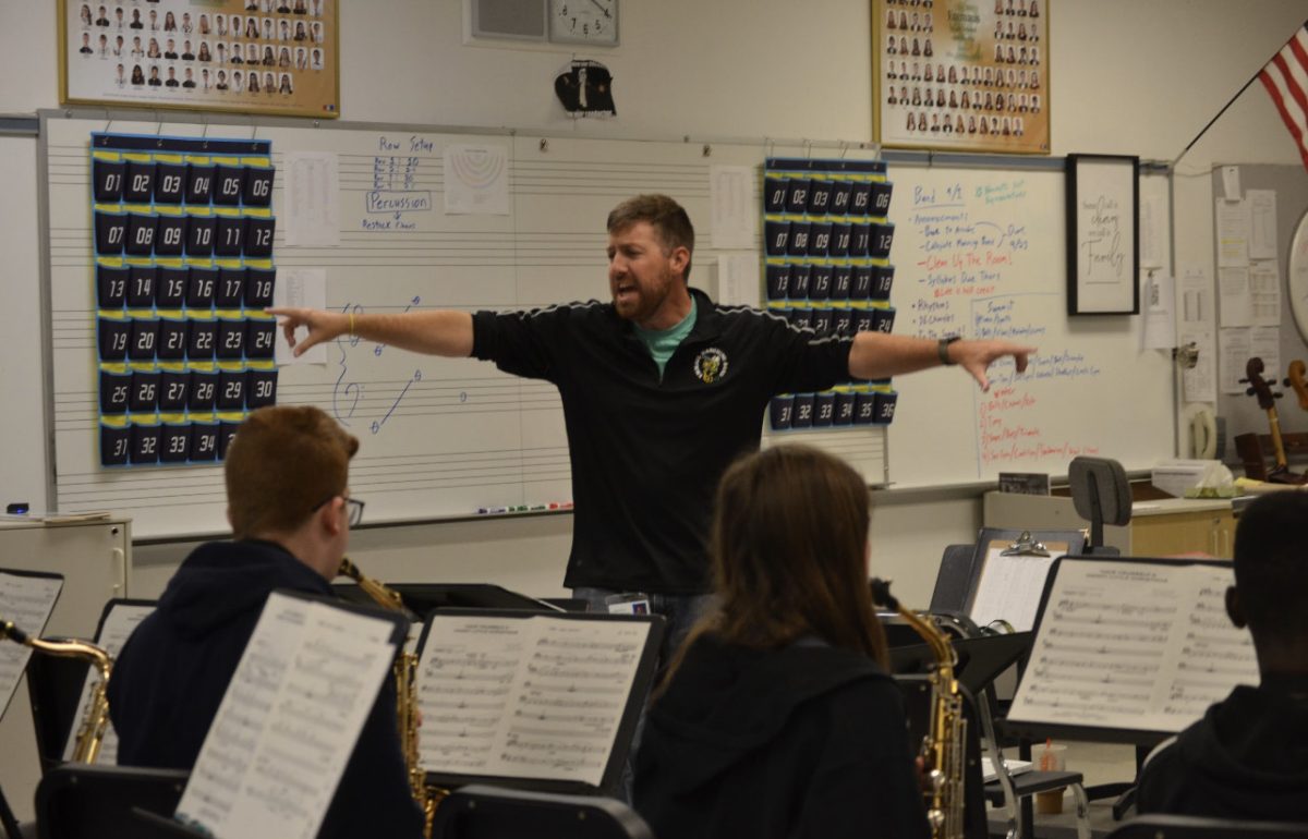 Koppenol conducting band students during a musical rehearsal. Photo by Gabe Meyers