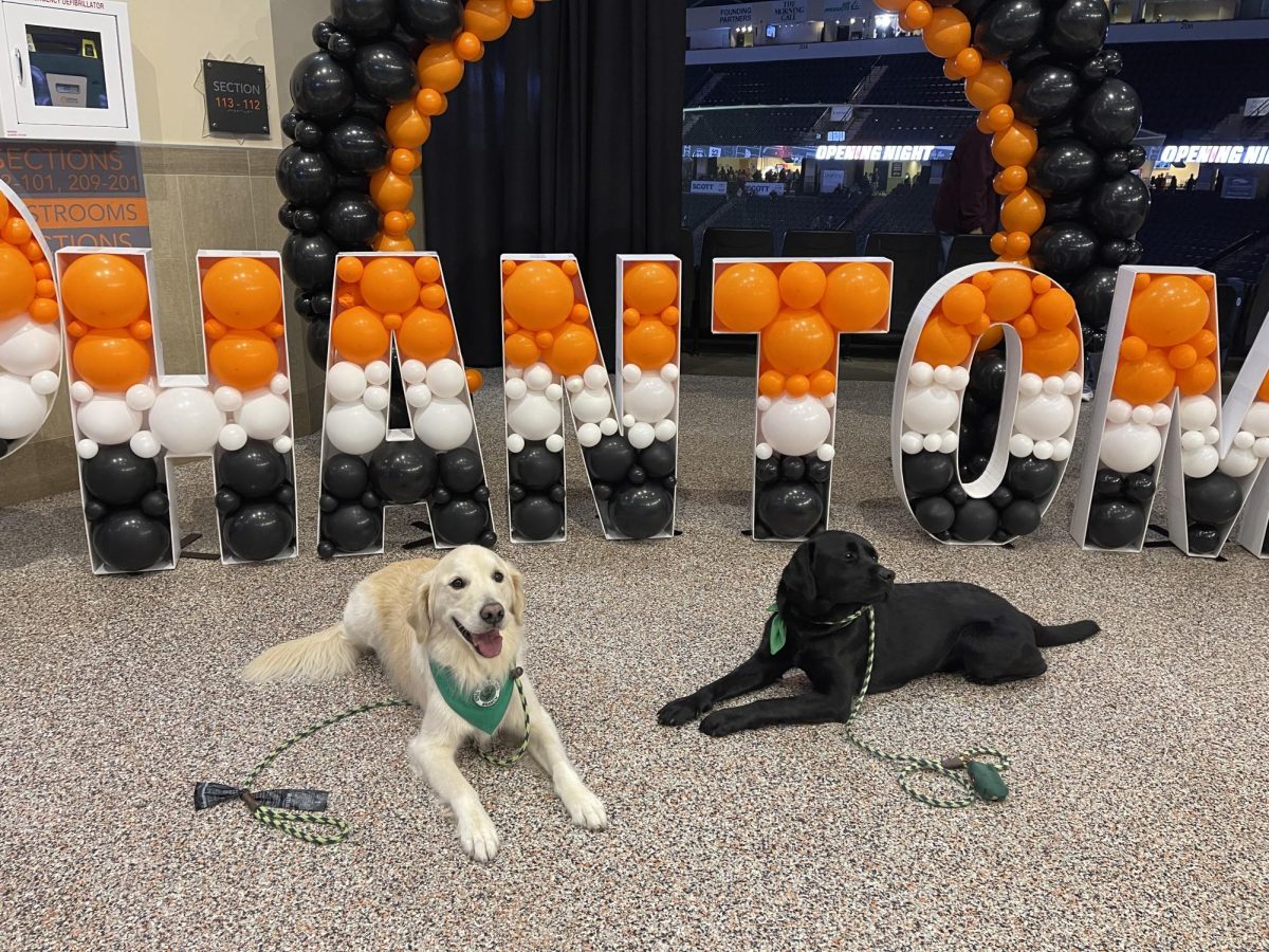 Branch and Tokyo in front of Phantoms sign at fundraiser.