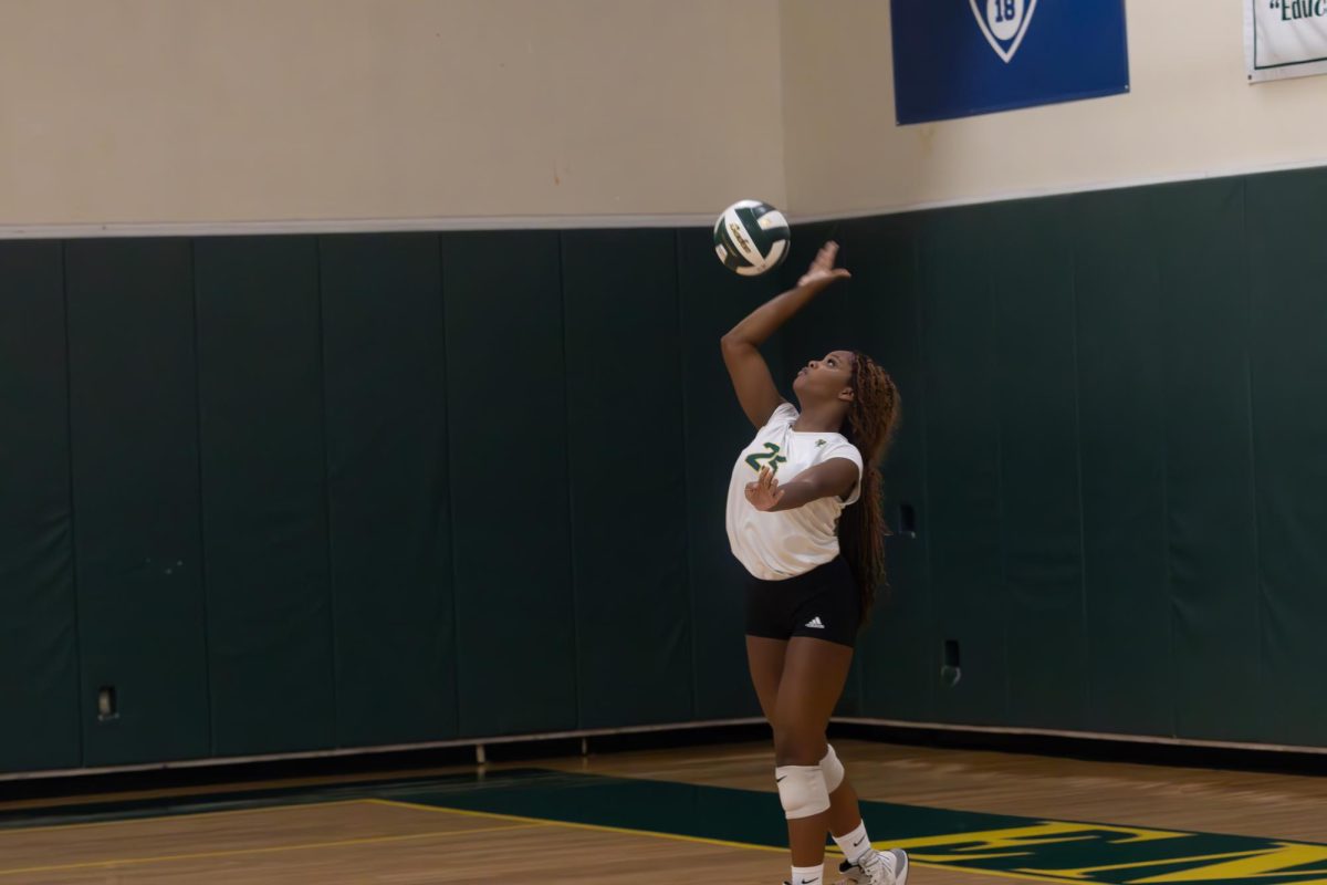 Junior Cirrae Cuffy serves volleyball during game on Sept. 24.