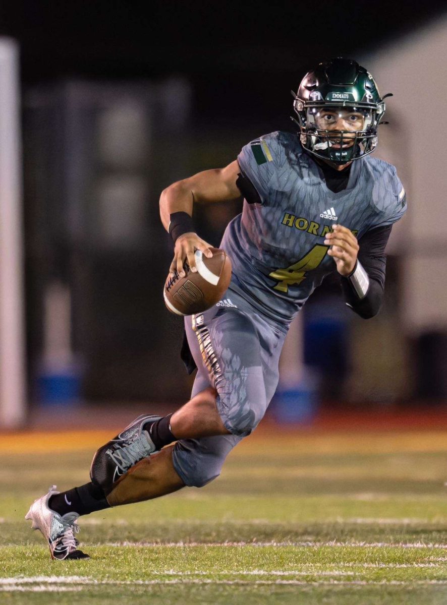 Junior Jerek Cooper rolls out scanning the field for an open receiver. Photo courtesy of Cooper.
