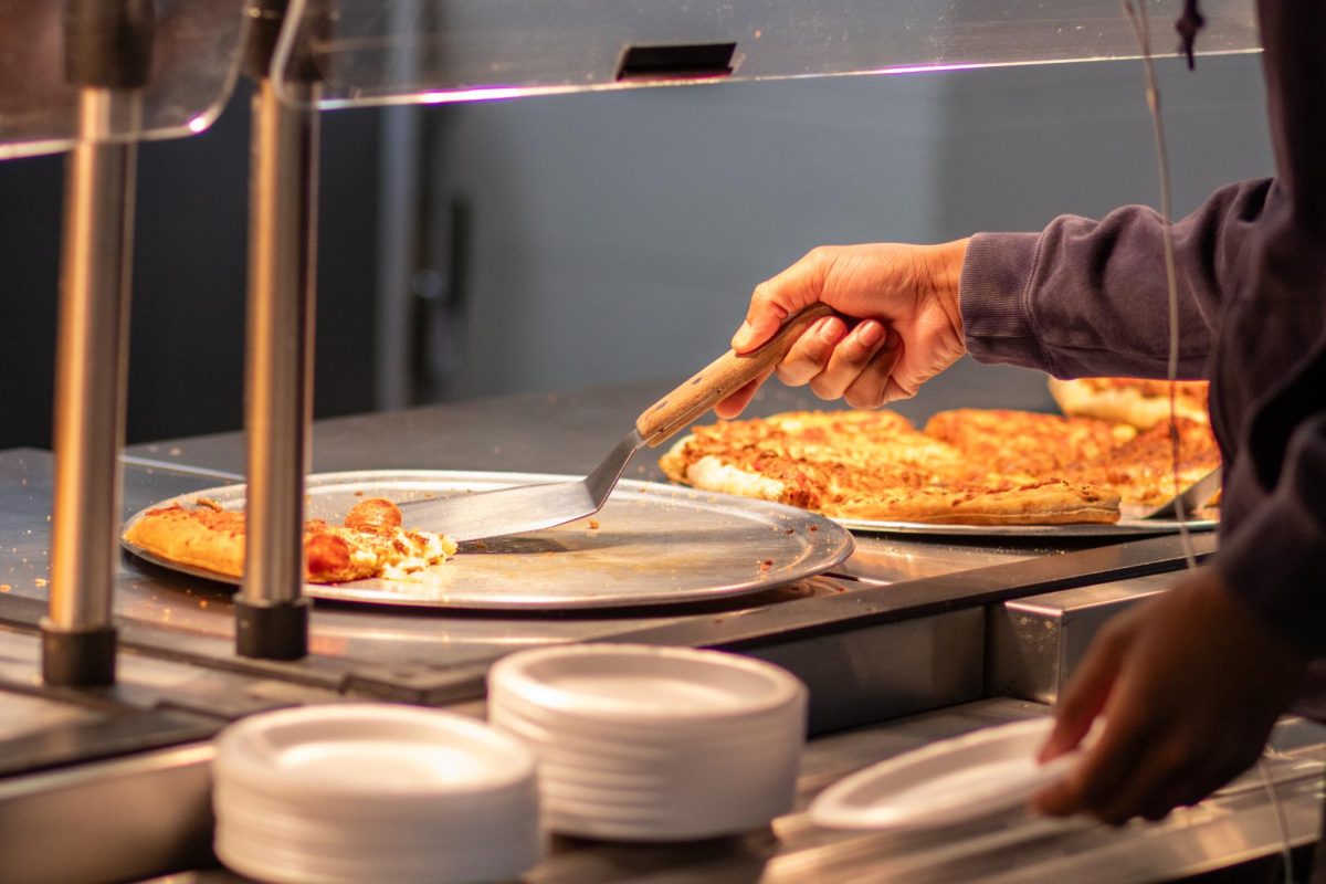 Student selecting pizza for lunch at the Emmaus High School cafeteria. Photo by Kamryn Vogel.